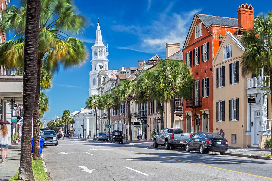 About Our Agency - Angled View of St. Michael's Church and Broad St. in Charleston, SC During a Sunny Day